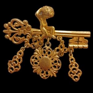 Vintage Skeleton Key Gold Tone Metal Brooch with Cupid and 5 Charms Brooch.